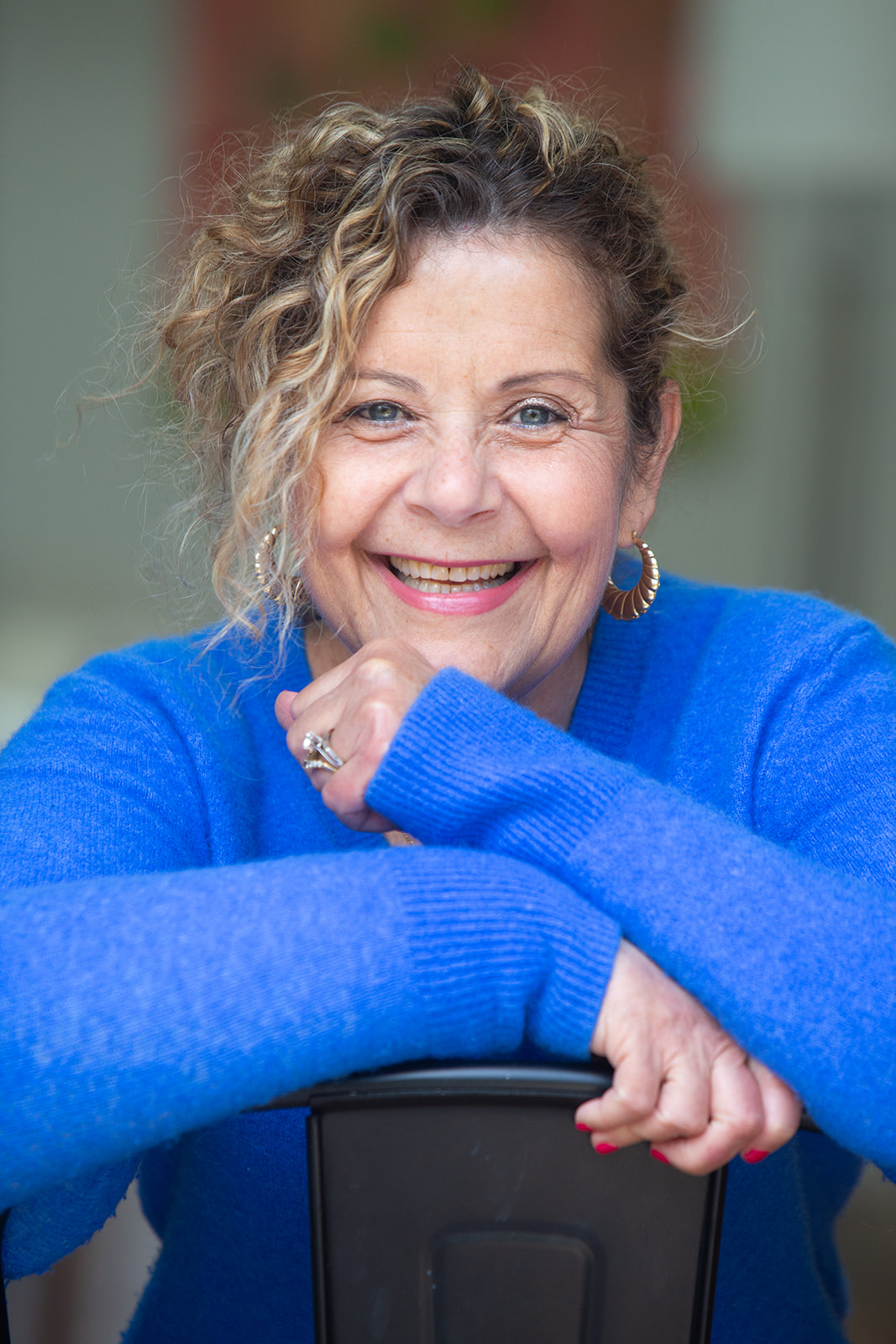 Margalit Grunberger leaning on the back of a chair